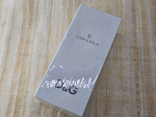 Product packaging with 'L'Amoureux' branding on a wooden surface